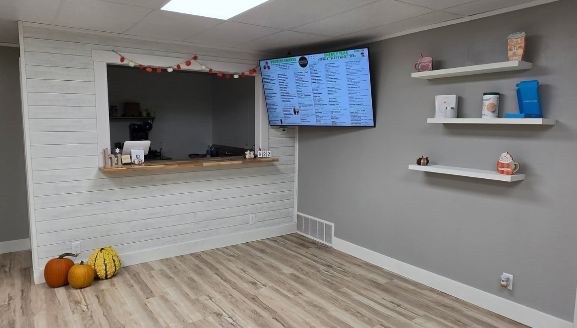 inside of Energy Nutrition - TV menu with front counter