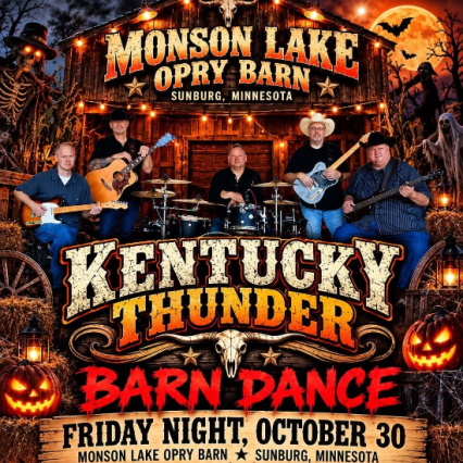 a band in front of a barn with halloween decor