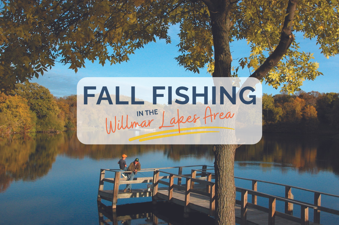 two men fishing on a pier with fall colors around the lake